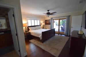 a bedroom with a bed and a ceiling fan at Bright and cheerful 4 bedroom home pool in Boca Raton