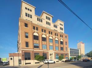 a large brick building on a street with cars parked in front at Silo View - heart of downtown in Waco