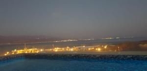 a view of a city at night with lights at Bay VIew in Eilat