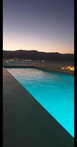 a swimming pool with blue water at dusk at Bay VIew in Eilat