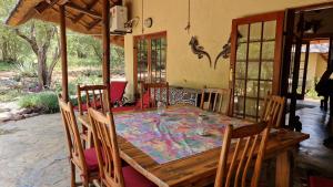 a dining room with a wooden table and chairs at Bona Intaba Game Lodge in Hoedspruit +40 photos