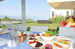 a table with plates of food on top of it at Lavender Residence in Kusadası