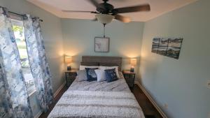 a bedroom with a bed and a ceiling fan at Cozy 2 bedroom home w/Lake View in Lorain