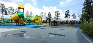 a playground with a slide in a park at SAZ Ivory in Semenyih