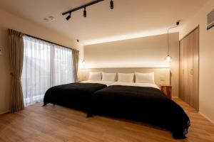 Un pat sau paturi într-o cameră la R.Kamakura