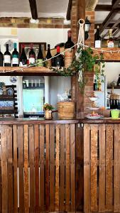 a bar in a kitchen with bottles of wine at Agriturismo Villa Assunta in Santa Caterina Villarmosa