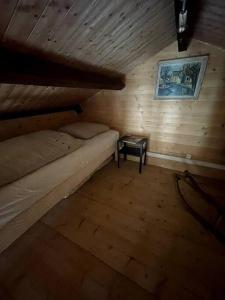 a bedroom with a bunk bed in a wooden room at la p'tit marennaise in Marennes