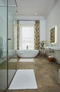 a large bathroom with a tub and a sink at Brookdale Estate - Manor House in Paarl