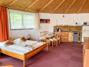 a bedroom with a large bed and a kitchen at Apartmany Jasna in Demanovska Dolina