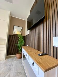 a living room with a tv on a wall at Villa Arche 2 in Neuenkirchen-Vörden +12 photos