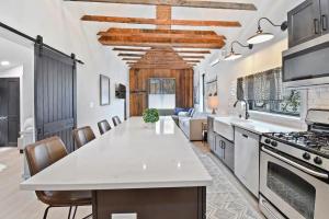 a large kitchen with a white counter top and a stove at Stylish Downtown 2BD Walk to Chairlifts in Park City +17 photos