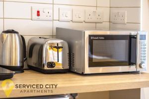 a microwave sitting on top of a kitchen counter at SCA - Best Located Studio - CR1 in Birmingham