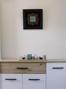 a wooden dresser in a room with a white wall at Tiny House Kosmaj in Sopot