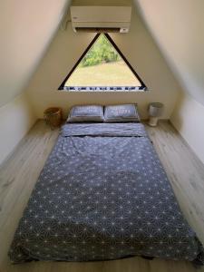 a bed in a room with a window at Tiny House Kosmaj in Sopot