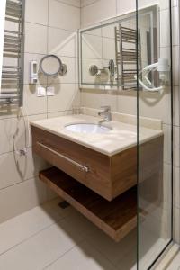 a bathroom with a sink and a shower at Hotel Hammamet in Alger