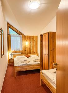 a bedroom with two beds and a window at Apartmany Jasna in Demanovska Dolina +27 photos