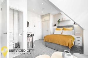 a white bedroom with a bed and a bathroom at SCA - Outstanding Studio - CR8 in Birmingham