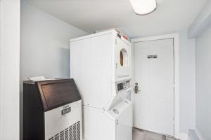 a white refrigerator and a microwave in a room at Upham Beach Inn - #3 Studio in St. Pete Beach