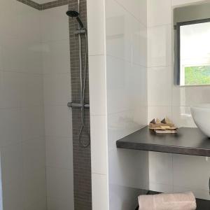 a white bathroom with a shower and a sink at Oustaou in Aubagne +9 photos