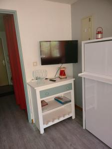 a white table with a tv on top of it at Studio St Lary village-vue montagne. in Saint-Lary-Soulan