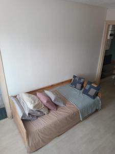uma cama com almofadas num quarto em Appartement résidence Sarciron em Le Mont-Dore