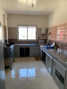 a kitchen with a stove and a counter top at Villa in Douar Ourlali