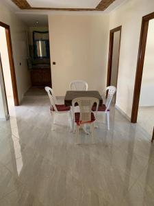 a dining room with a table and four chairs at Villa in Douar Ourlali
