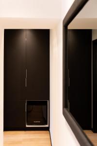 a black entertainment center with a tv in a room at City Premium Heritage in Zadar