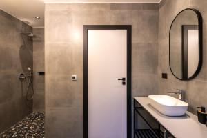 a bathroom with a sink and a mirror at City Premium Heritage in Zadar