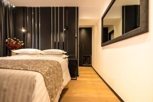 a hotel room with a bed and a mirror at City Premium Heritage in Zadar
