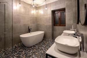 a bathroom with a tub and a toilet and a sink at City Premium Heritage in Zadar