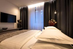 a bedroom with a large bed and a television at City Premium Heritage in Zadar