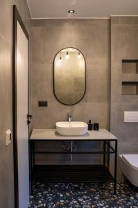 a bathroom with a sink and a mirror at City Premium Heritage in Zadar