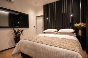a bedroom with a large bed with white sheets and pillows at City Premium Heritage in Zadar