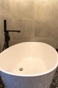 a large white bath tub in a bathroom at City Premium Heritage in Zadar