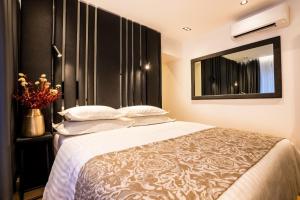 a bedroom with a large bed and a mirror at City Premium Heritage in Zadar