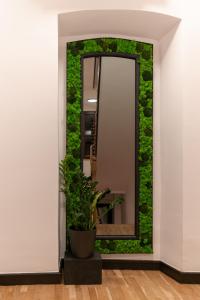 a mirror with green ivy on a wall at City Premium Heritage in Zadar