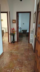 a room with a hallway with a vase of flowers at Appartamento Ida vacanza mare in Policoro