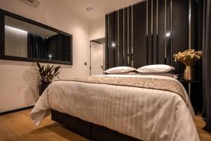 a bedroom with a large bed with white sheets and pillows at City Premium Heritage in Zadar