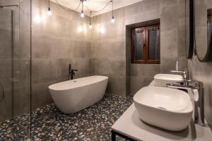 a bathroom with a tub and a toilet and a sink at City Premium Heritage in Zadar