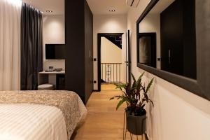 a bedroom with a bed and a potted plant at City Premium Heritage in Zadar