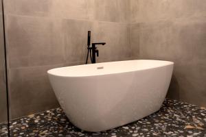 a white bath tub sitting on a counter in a bathroom at City Premium Heritage in Zadar