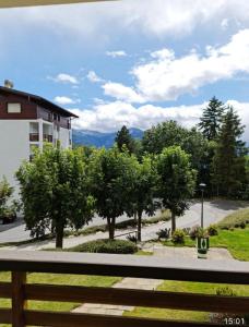 a view of a park with trees and a building at Appartement 60m2- vue sur la montagne in Crans-Montana