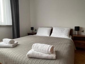 a bedroom with a bed with two towels on it at Dolce Vita in Mszana Dolna