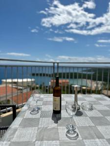 a bottle of wine sitting on a table with wine glasses at Montenegrina Apartment in Budva
