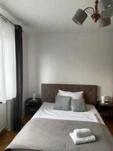 a bedroom with a large bed with two pillows at Dolce Vita in Mszana Dolna