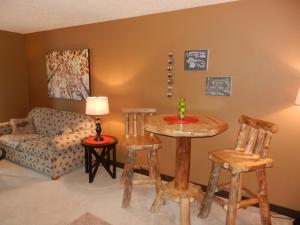 a living room with a table and chairs and a couch at Great Northern Hotel in Mercer
