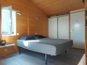 a bedroom with a large bed in a wooden room at Cape Agde Charmant chalet sur le Mont Saint Loup in Agde