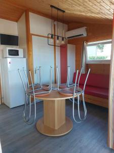 a table and chairs in a tiny house at Cape Agde Charmant chalet sur le Mont Saint Loup in Agde