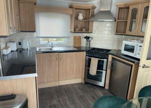 a small kitchen with a sink and a stove at Pendle Hill View in Preston